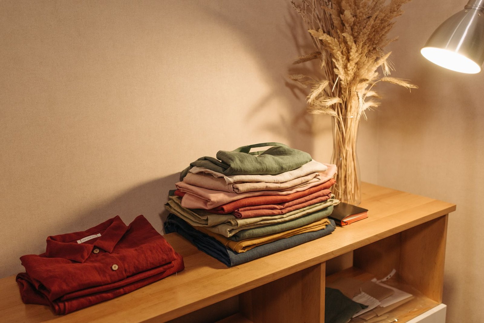 Neatly folded clothing in warm, natural tones